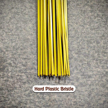 Hard bristle broom with plastic handle, close-up of bristles