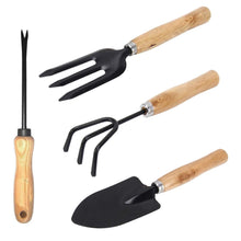 Gardening tools set with spade, rake, and trowel.